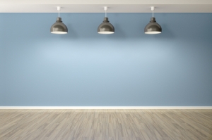 An image of an empty blue room with three lamps